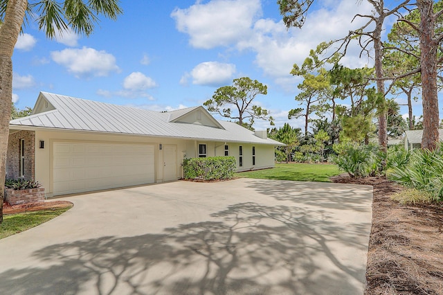 view of front of home with a garage and a front yard