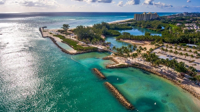 birds eye view of property with a water view and a beach view