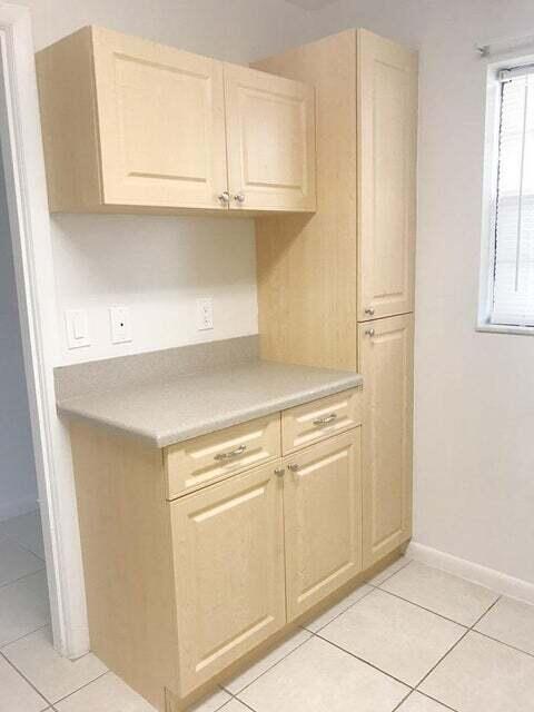 kitchen featuring light brown cabinetry and light tile floors