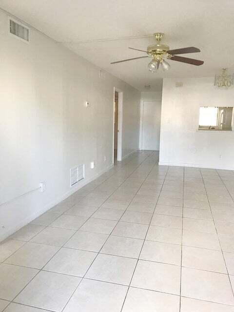 spare room featuring ceiling fan and light tile flooring