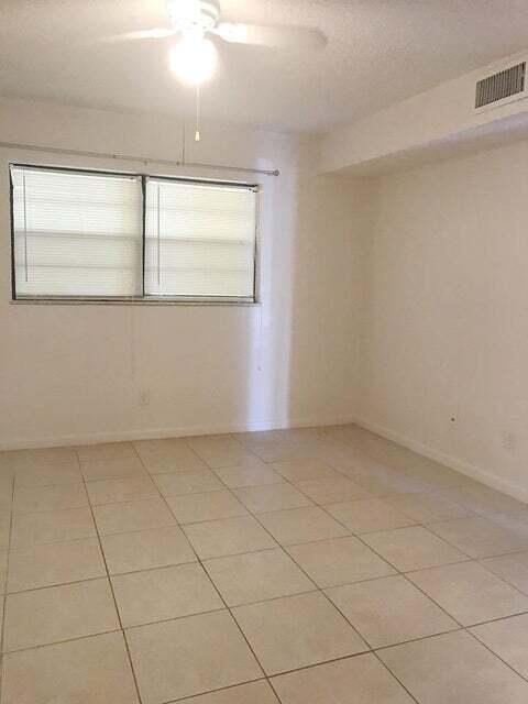 spare room featuring ceiling fan and light tile flooring