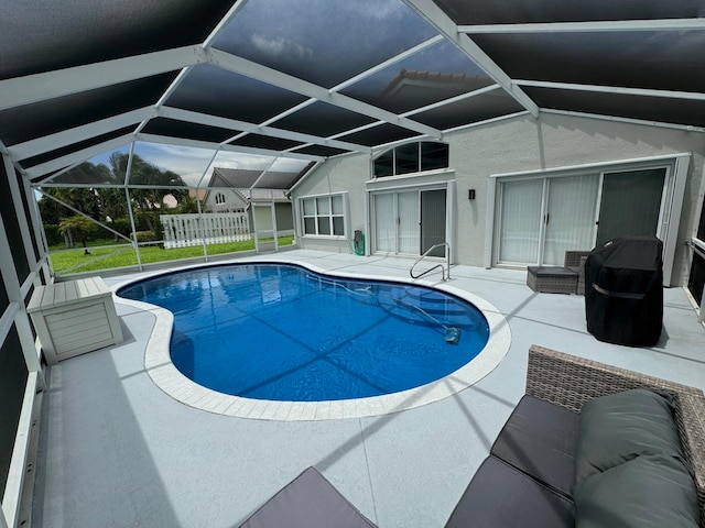 view of pool featuring a patio and glass enclosure