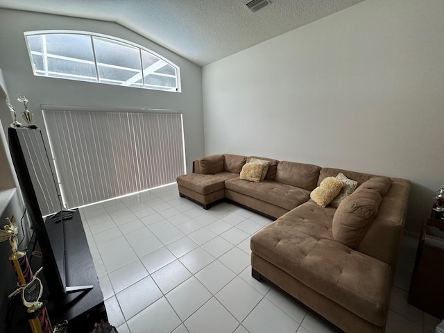 tiled living room with a textured ceiling and vaulted ceiling