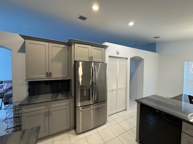 kitchen with stainless steel fridge with ice dispenser, light tile patterned floors, gray cabinets, and dishwasher