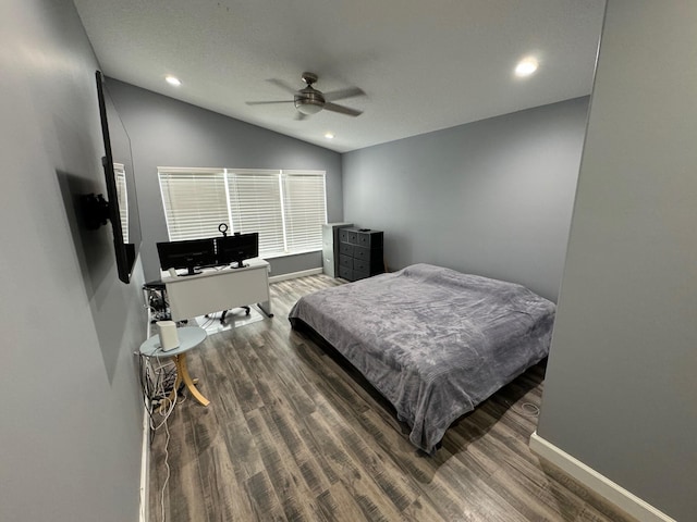 bedroom featuring ceiling fan, hardwood / wood-style flooring, and vaulted ceiling