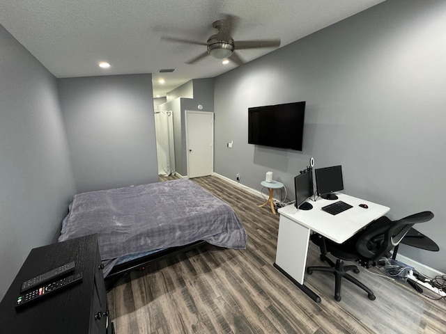 bedroom with ceiling fan, a textured ceiling, and wood-type flooring