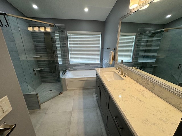 bathroom with tile patterned floors, vanity, and plus walk in shower