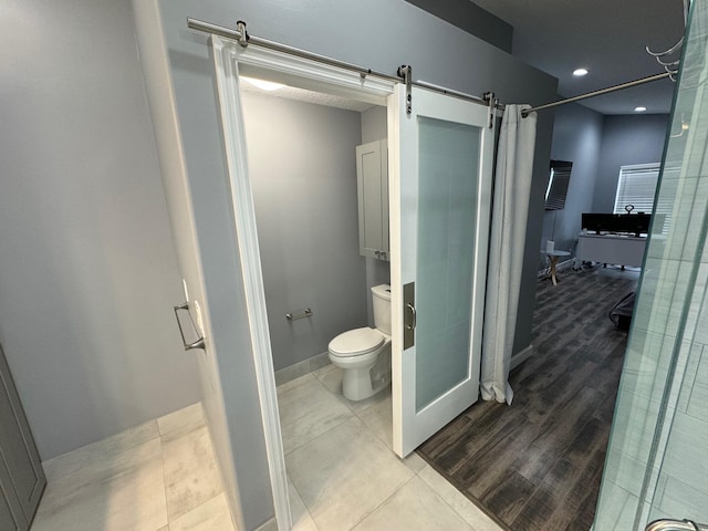 bathroom featuring toilet and hardwood / wood-style floors