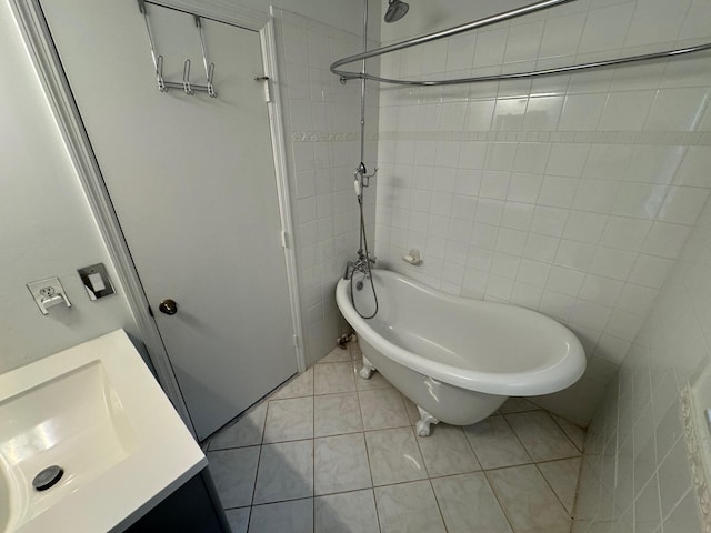 bathroom featuring tile patterned floors, tile walls, shower / bathtub combination, and vanity