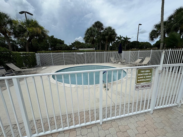 view of swimming pool with a patio