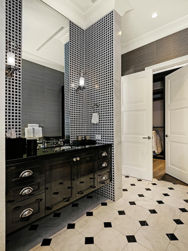 bathroom featuring wood-type flooring, sink, and ornamental molding