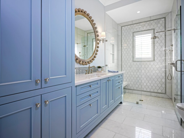 bathroom with vanity, a shower with shower door, tile floors, and toilet