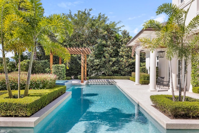 view of pool with a pergola and a patio area