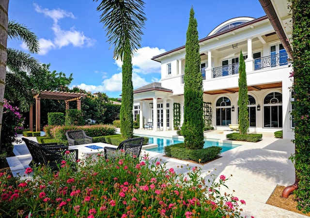 view of pool with french doors, a pergola, and a patio area