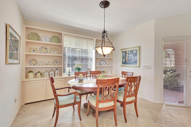 kitchen featuring light stone counters, light tile floors, sink, tasteful backsplash, and black appliances