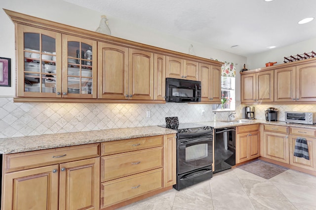 kitchen featuring black appliances, ceiling fan, light tile floors, and light stone countertops