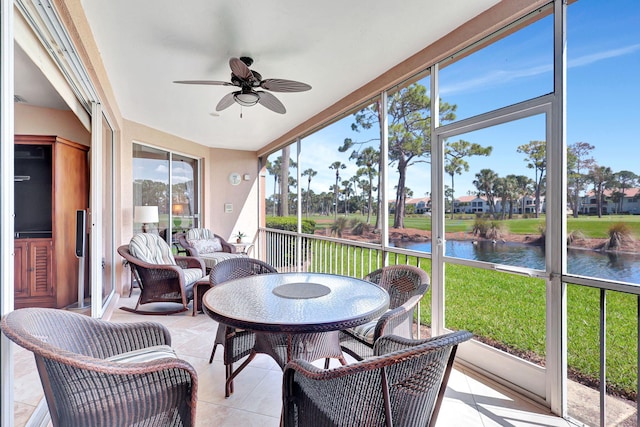 sunroom / solarium with a water view, a wealth of natural light, and ceiling fan