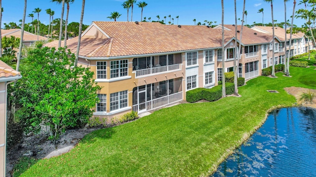 back of property with a lawn and a sunroom