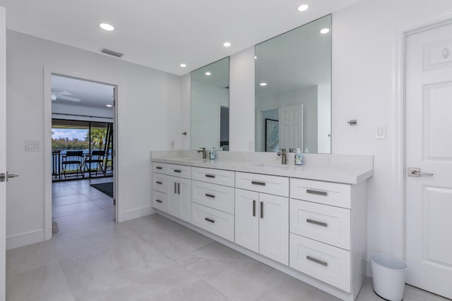 bathroom with tile flooring, ceiling fan, and large vanity