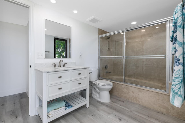 bathroom with hardwood / wood-style flooring, toilet, and vanity