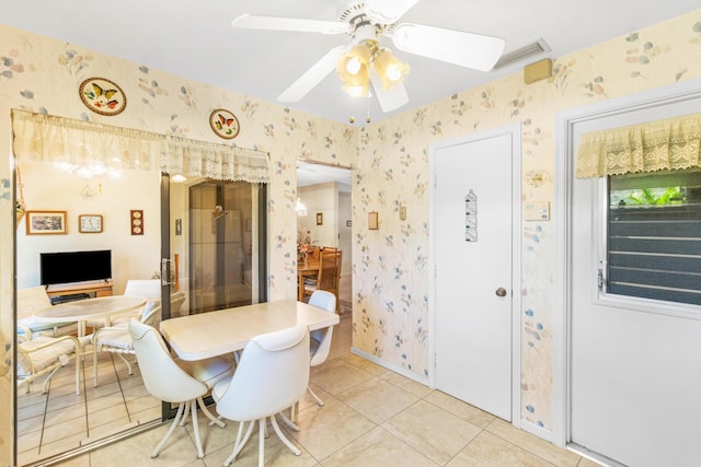 dining area featuring wallpapered walls, light tile patterned floors, visible vents, and a ceiling fan