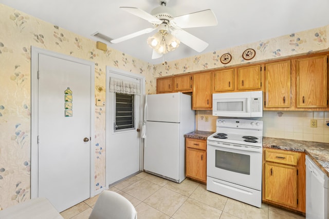 kitchen featuring white appliances, light tile patterned floors, wallpapered walls, brown cabinetry, and ceiling fan