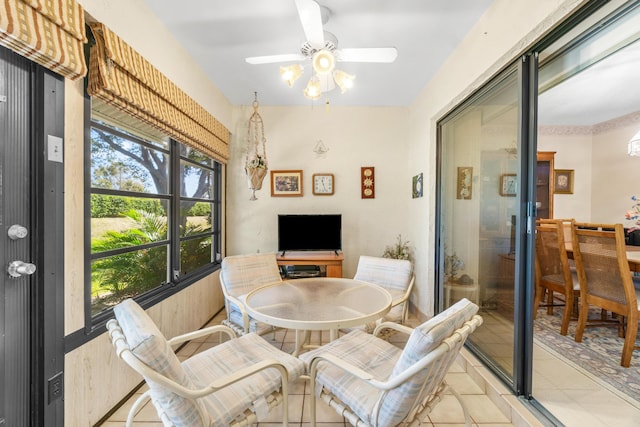 sunroom / solarium with a ceiling fan