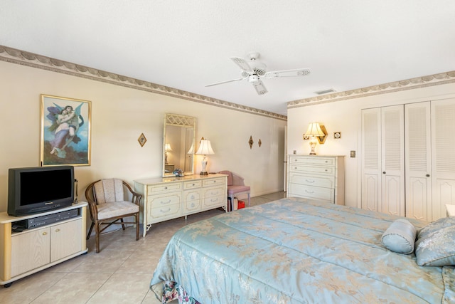 bedroom with a ceiling fan, a closet, visible vents, and light tile patterned floors