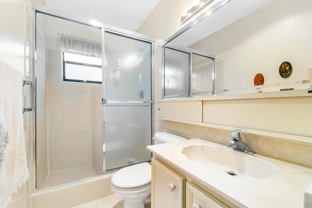 bathroom with vanity, a shower stall, and toilet