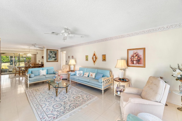 living area with ceiling fan, a textured ceiling, and light tile patterned floors