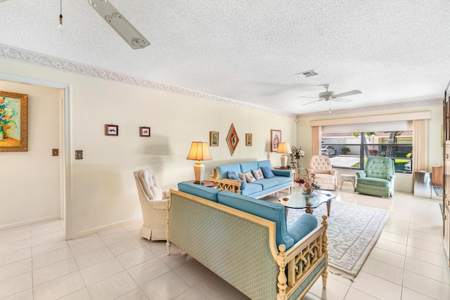 living area featuring baseboards, visible vents, a ceiling fan, a textured ceiling, and light tile patterned flooring