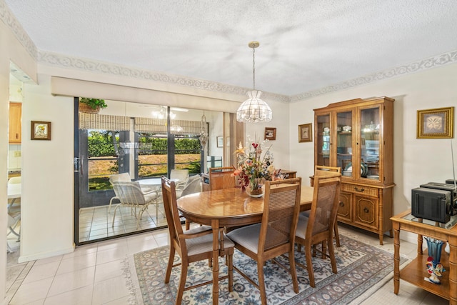 dining room with a textured ceiling, light tile patterned floors, and a chandelier