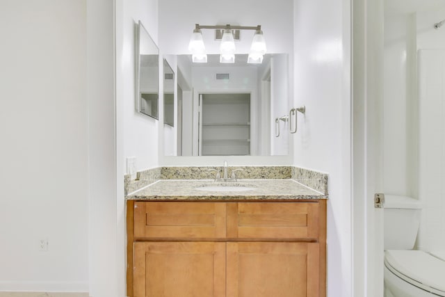 bathroom featuring vanity and toilet