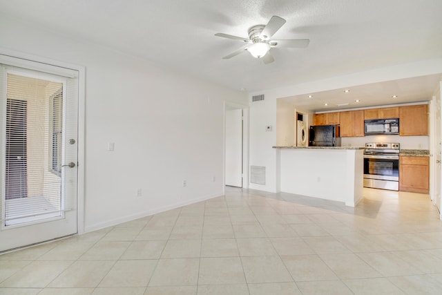 unfurnished living room featuring ceiling fan and light tile floors