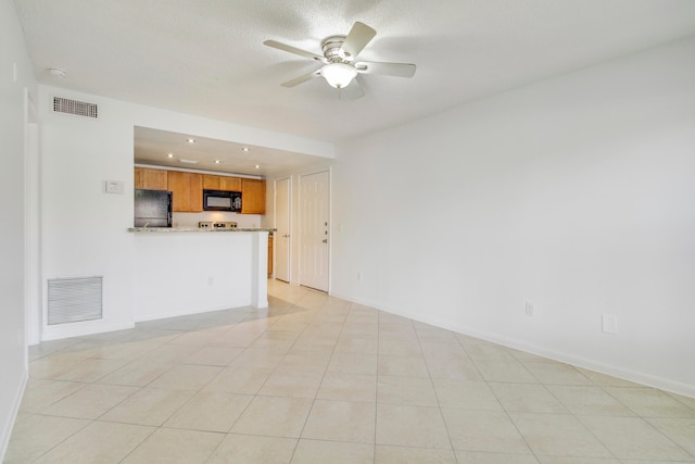 unfurnished living room with ceiling fan and light tile flooring