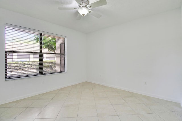 tiled empty room with ceiling fan