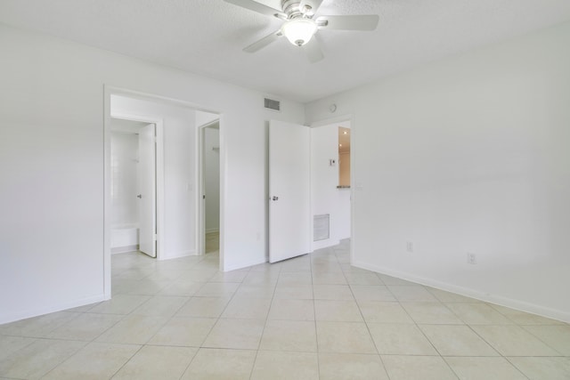 tiled empty room with ceiling fan