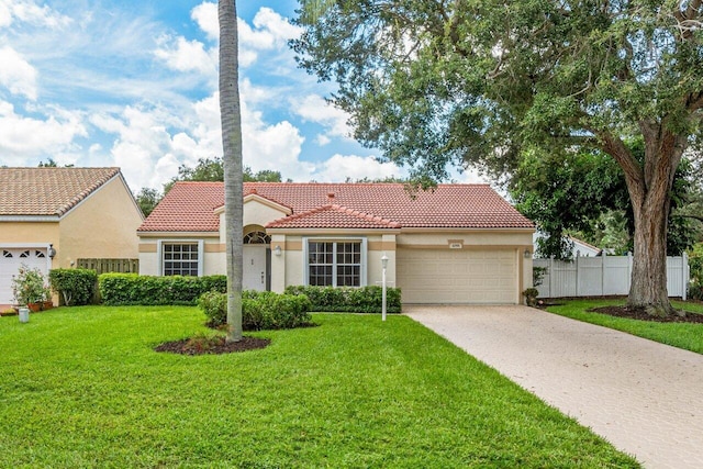 view of front of home featuring a garage and a front lawn