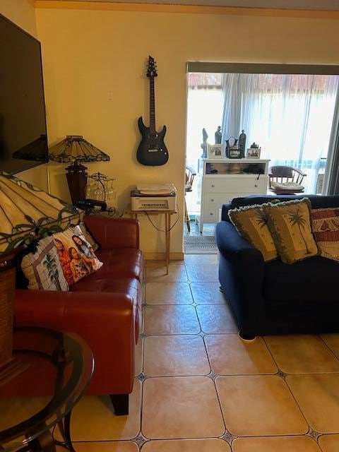 living room featuring a healthy amount of sunlight and light tile flooring