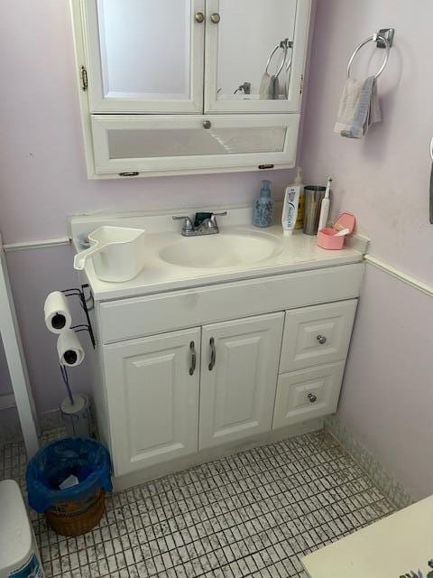 bathroom with tile flooring and vanity