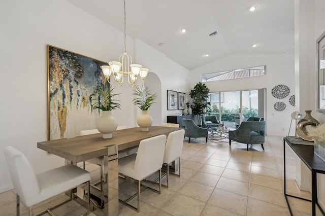 tiled dining space featuring high vaulted ceiling and a chandelier