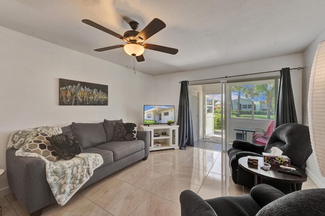 tiled living room with ceiling fan and brick wall