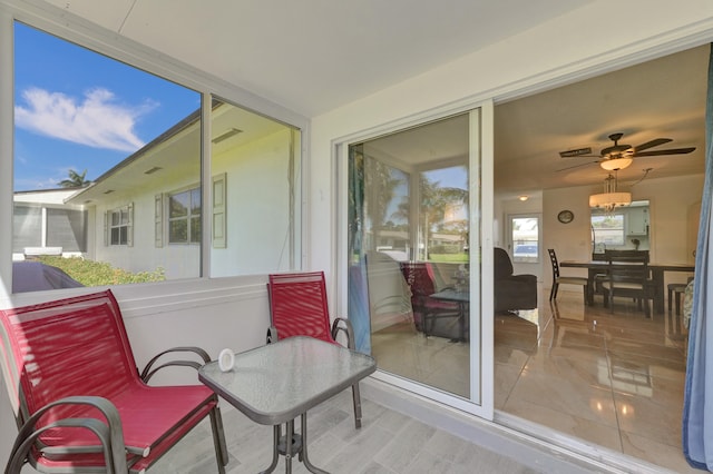 sunroom / solarium with ceiling fan