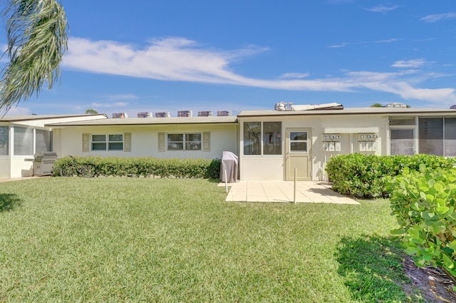 rear view of property with a lawn