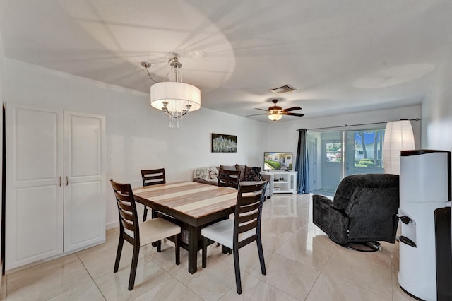 dining room featuring light tile flooring and ceiling fan with notable chandelier