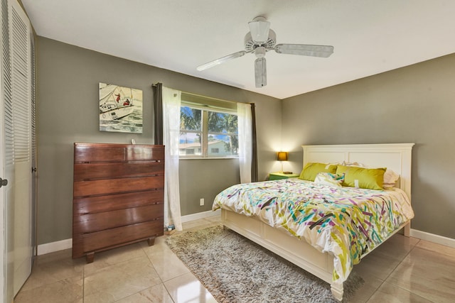 bedroom featuring a closet, ceiling fan, and light tile floors