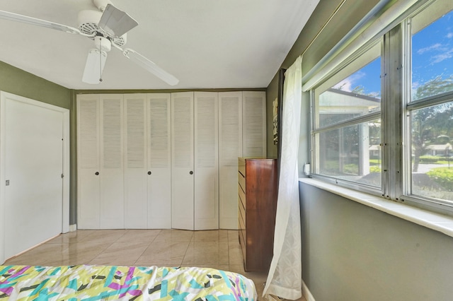 bedroom featuring ceiling fan and light tile floors