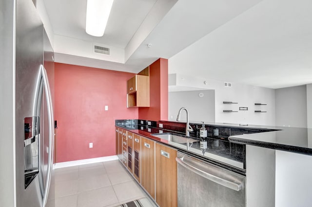 kitchen featuring sink, light tile patterned floors, and stainless steel appliances