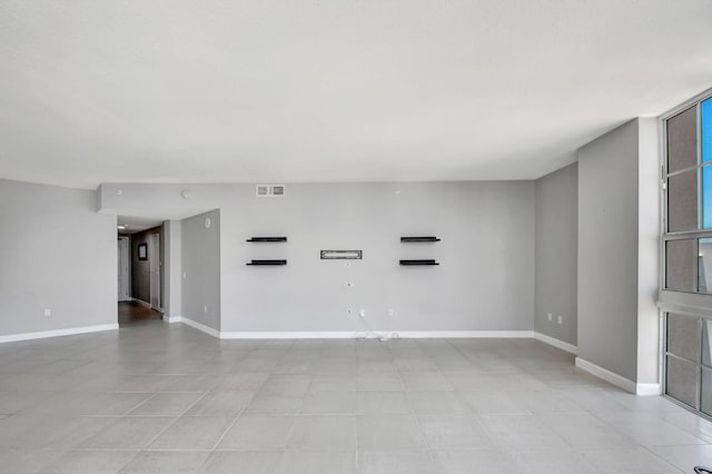 unfurnished living room with light tile patterned flooring