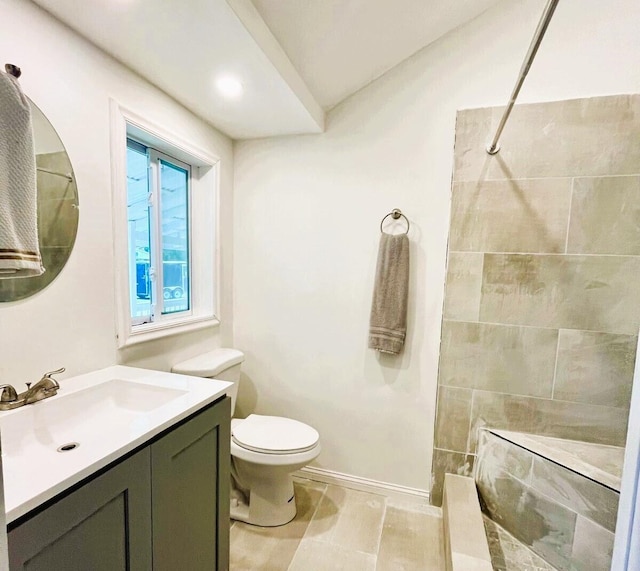 bathroom with vanity, toilet, and tile flooring